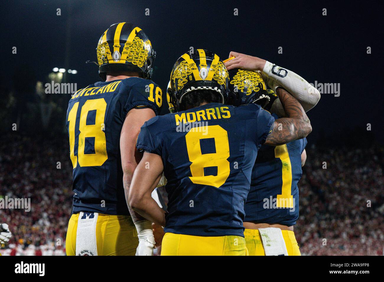 Michigan Wolverines wide receiver Tyler Morris (8) celebrates with tight end Colston Loveland (18) and wide receiver Roman Wilson (1) during the CFP S Stock Photo