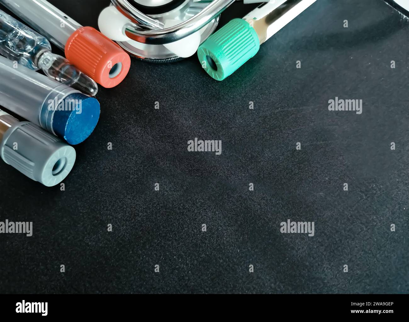 medicine, diabetes, advertisement and health care concept - close up of glucometer with blood sugar test stripe, insulin injection syringes and pills Stock Photo