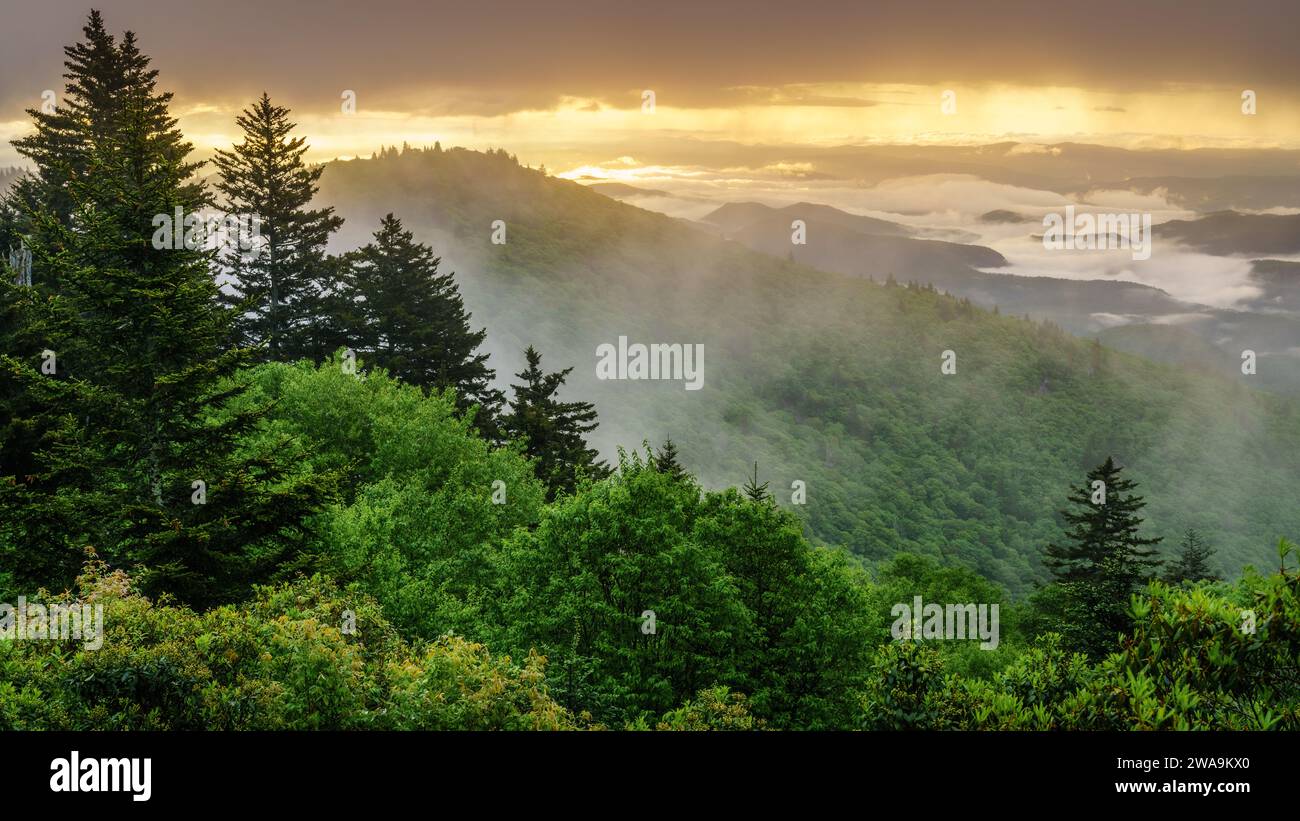 View of the Smokie Mountains from Blue Ridge Parkway with dramatic evening skies and fog rising from the valleys Stock Photo