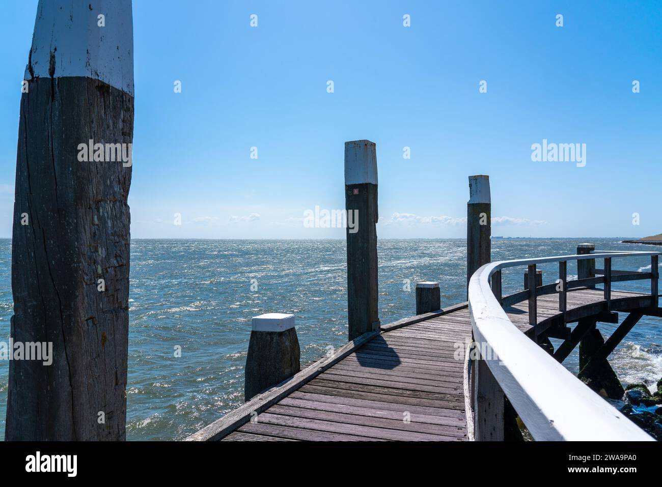 On a beautiful day at the see is whit a pier for ships Stock Photo