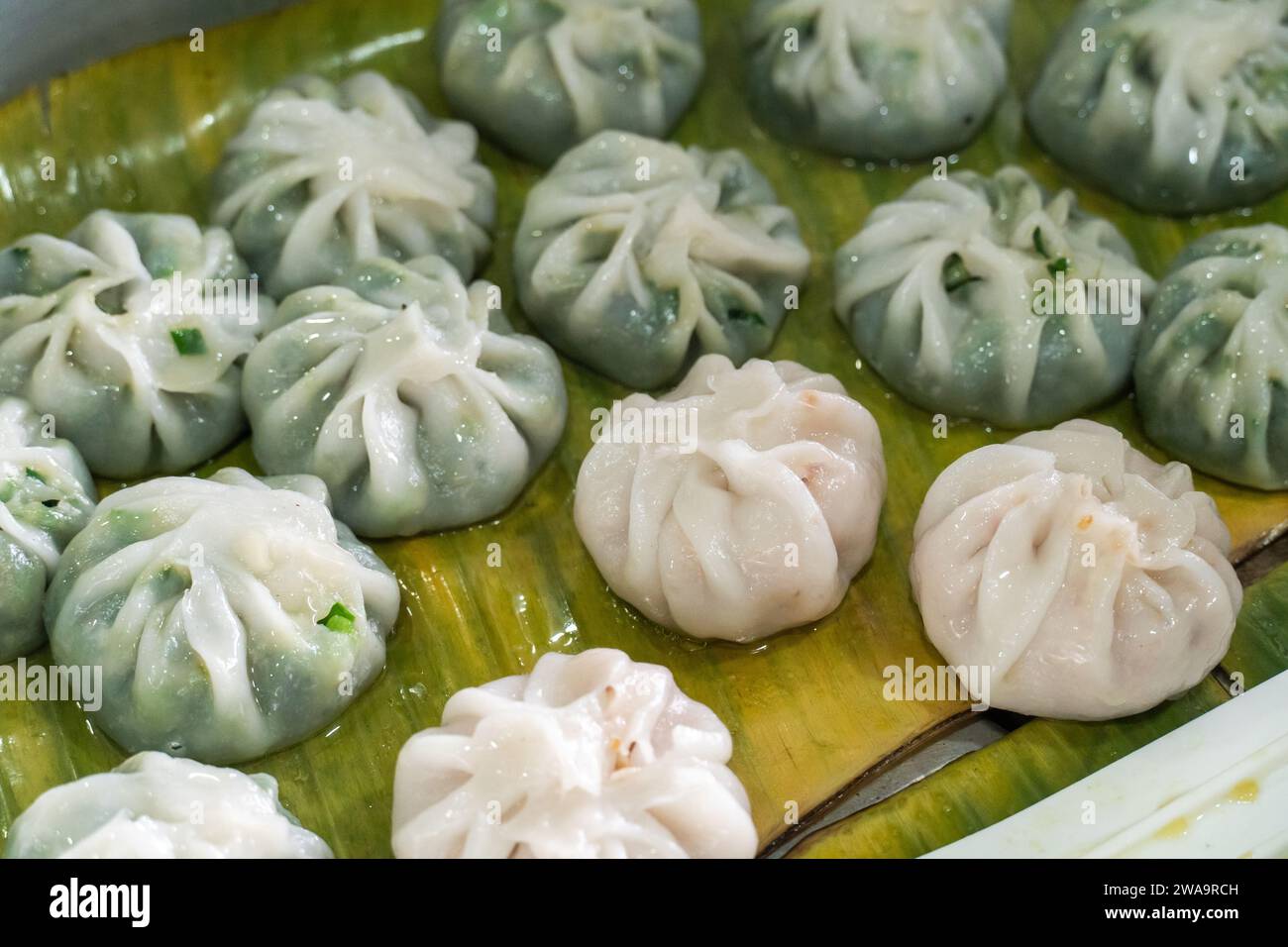 Pork and chives dumplings on banana leaves. Traditional Thai Street ...