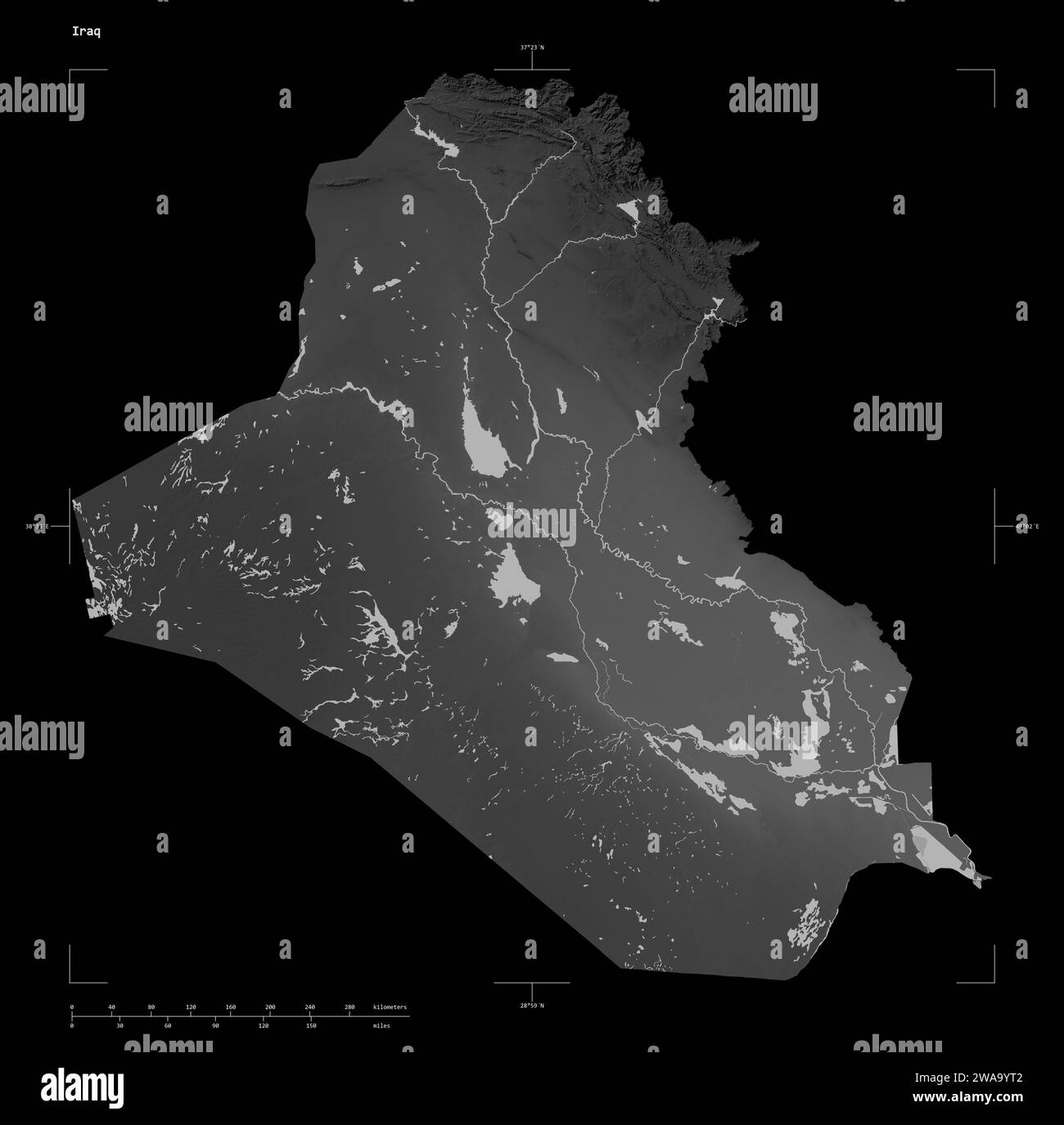 Shape of a Grayscale elevation map with lakes and rivers of the Iraq, with distance scale and map border coordinates, isolated on black Stock Photo