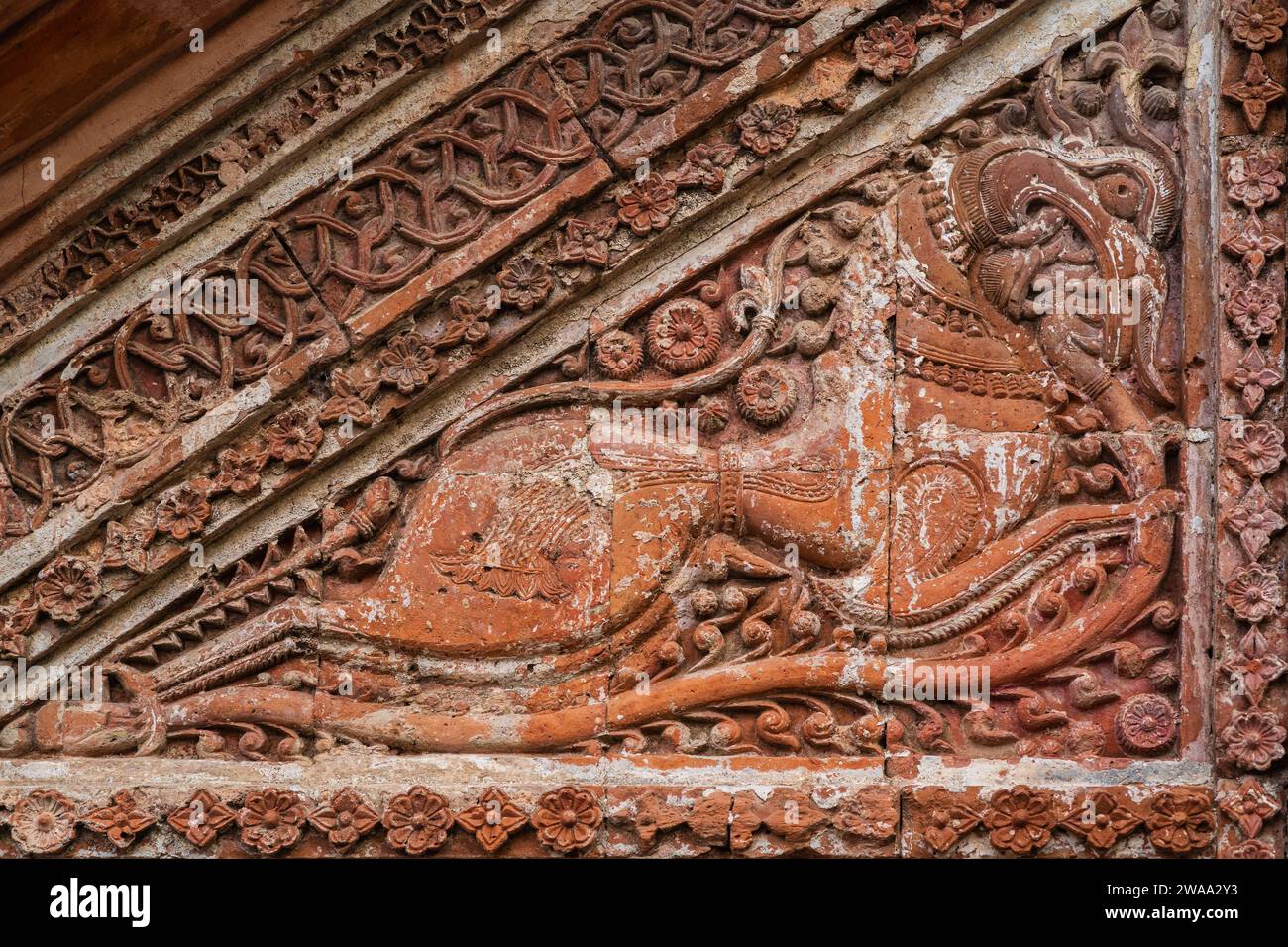 Closeup view of carved terracotta mythological horselike creature on exterior of Chota Anhik ancient hindu temple, Puthia, Rajshahi, Bangladesh Stock Photo