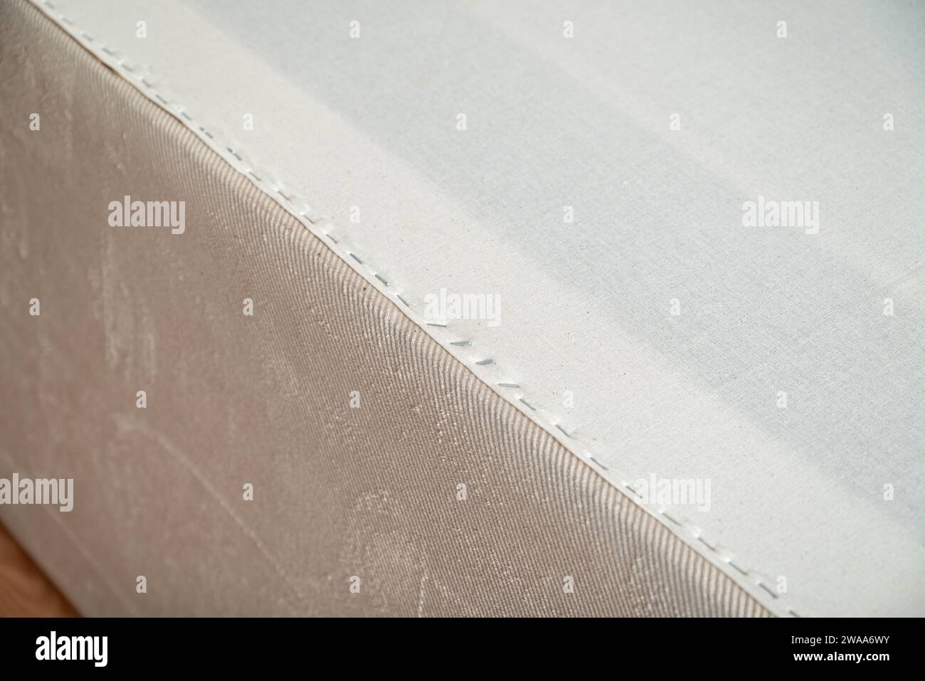 New fabric applied with staples to replace the worn out fusible