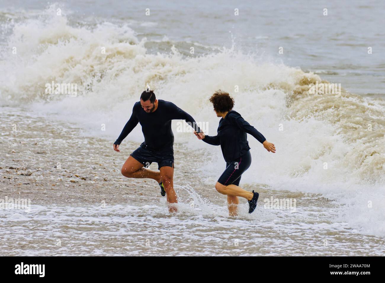 Number 1 in a sequence of 4: swimming at Avon Beach, Mudeford, Christchurch, Dorset on New Year's Day Stock Photo