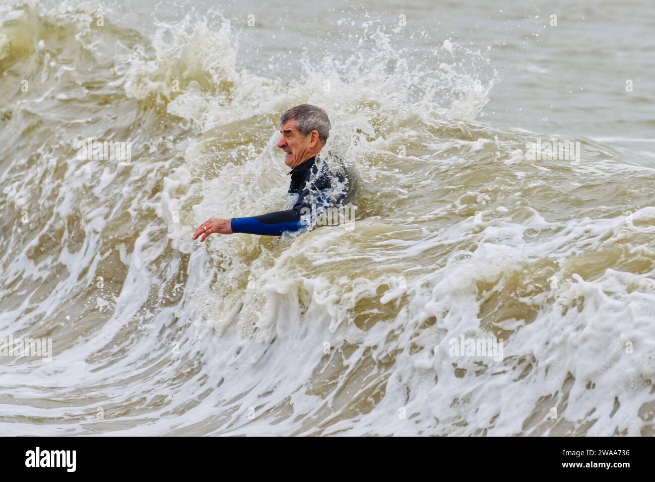 Number 3 in a sequence of 4: swimming at Avon Beach, Mudeford, Christchurch, Dorset on New Year's Day Stock Photo