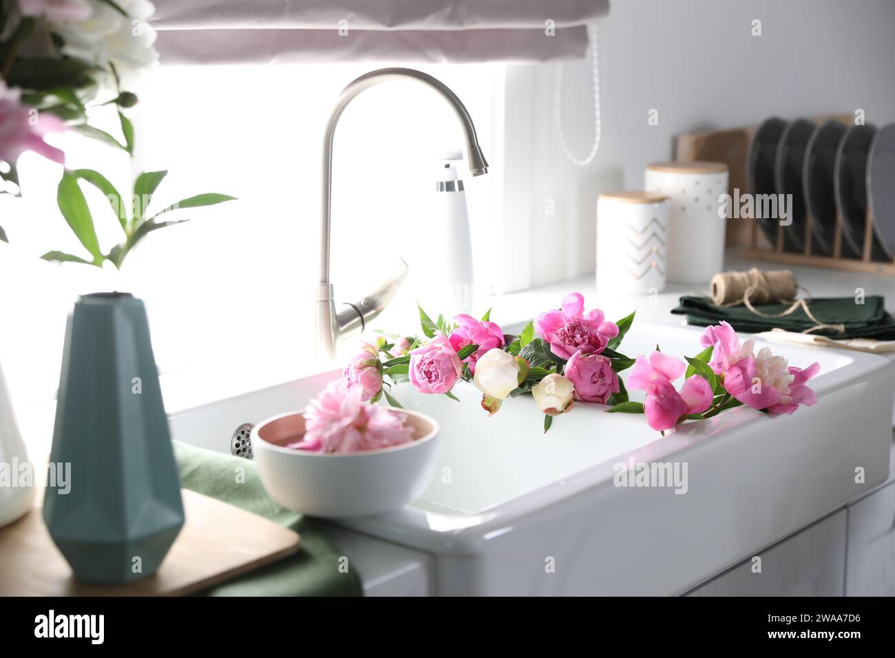 Bunch of beautiful peonies in kitchen sink Stock Photo - Alamy