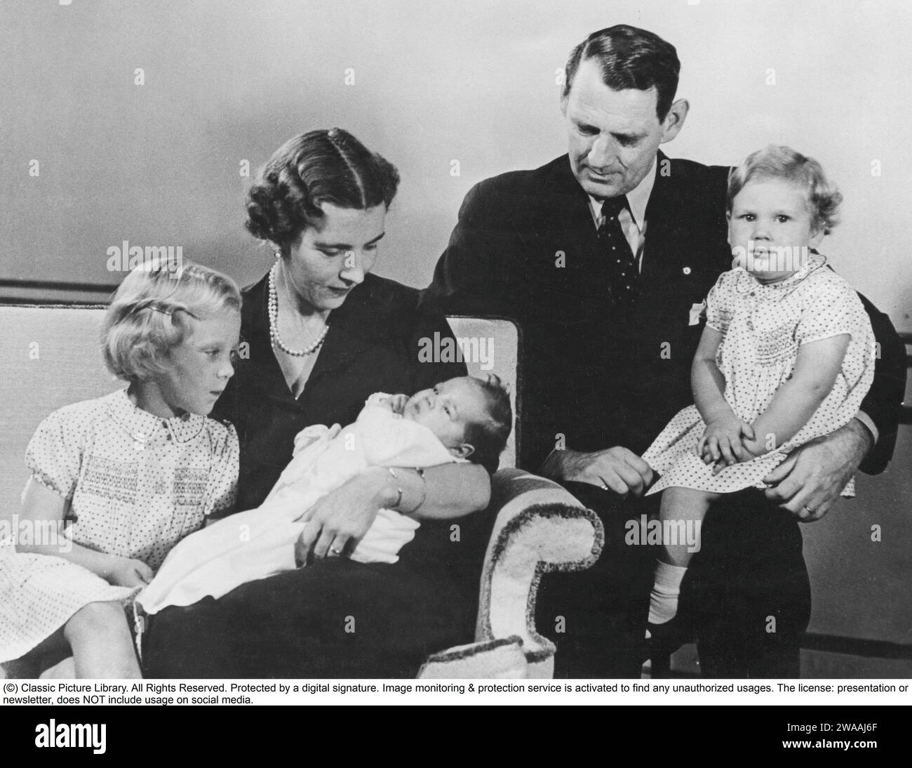 Queen Margrethe II of Denmark.  Pictured with her mother and father, Ingrid of Sweden and king Frederick IX of Denmark. Princess Benedikte in her fathers knee. Princess Anne-Marie in Ingrids arms.  1946 Stock Photo