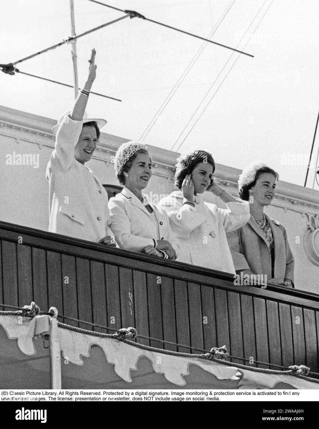 Queen Margrethe II of Denmark. Pictured with her mother Ingrid of Sweden and her sisters Anne-Marie and Benedikte when attending the wedding of swedish princess Margaretha 1964. Waving from the royal ship Dannebrogen. Stock Photo