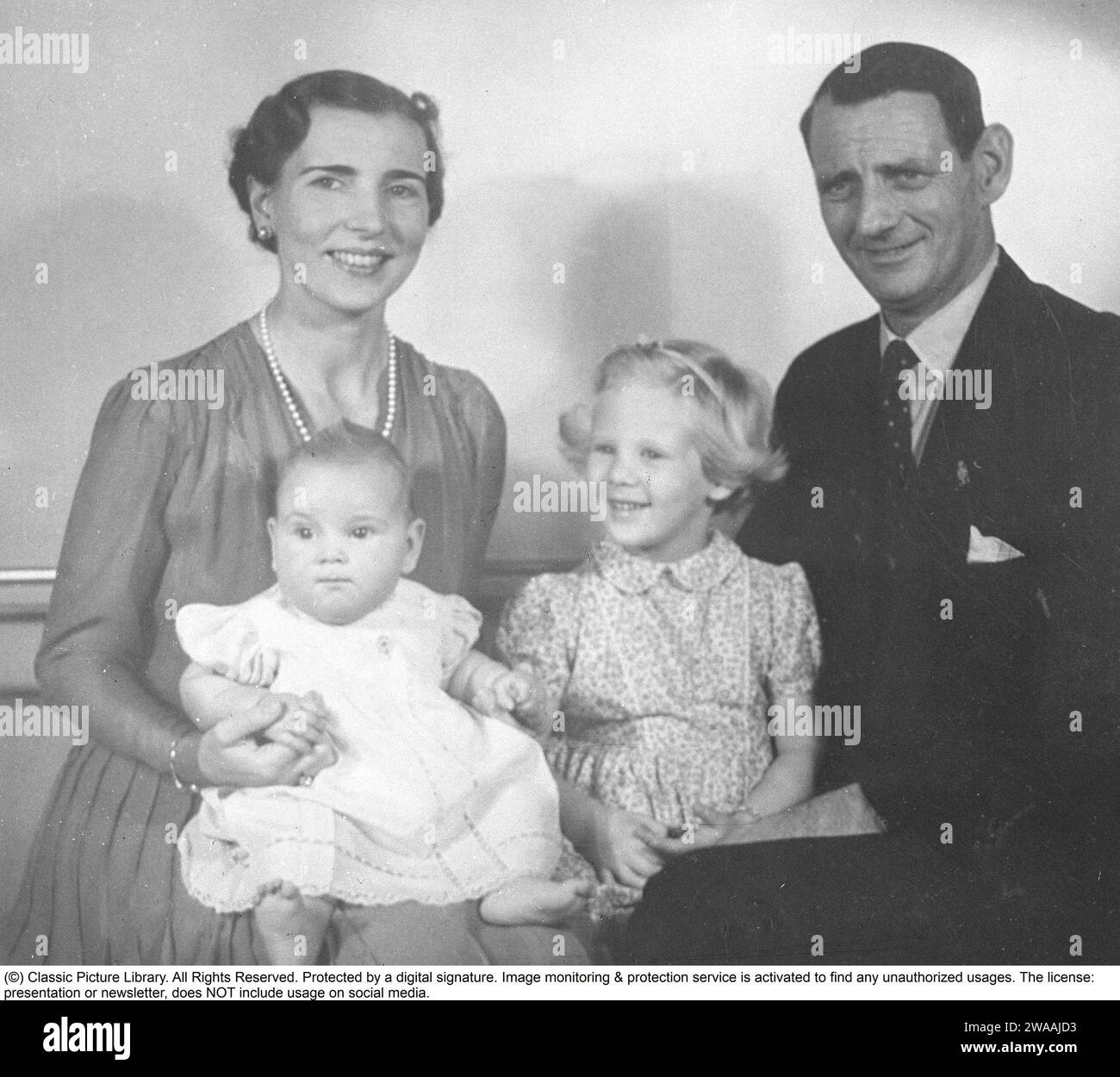 Queen Margrethe II of Denmark.  Pictured with her mother and father, Ingrid of Sweden and king Frederick IX of Denmark. Princess Benedikte in her mothers knee. 1944 Stock Photo