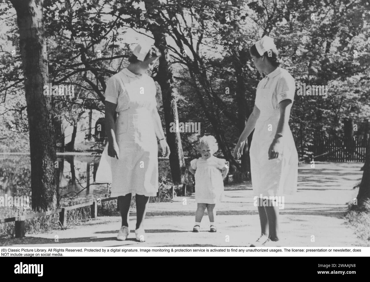 Queen Margrethe II of Denmark. Pictured walking on her own with two child nurses 15 march 1941. Stock Photo