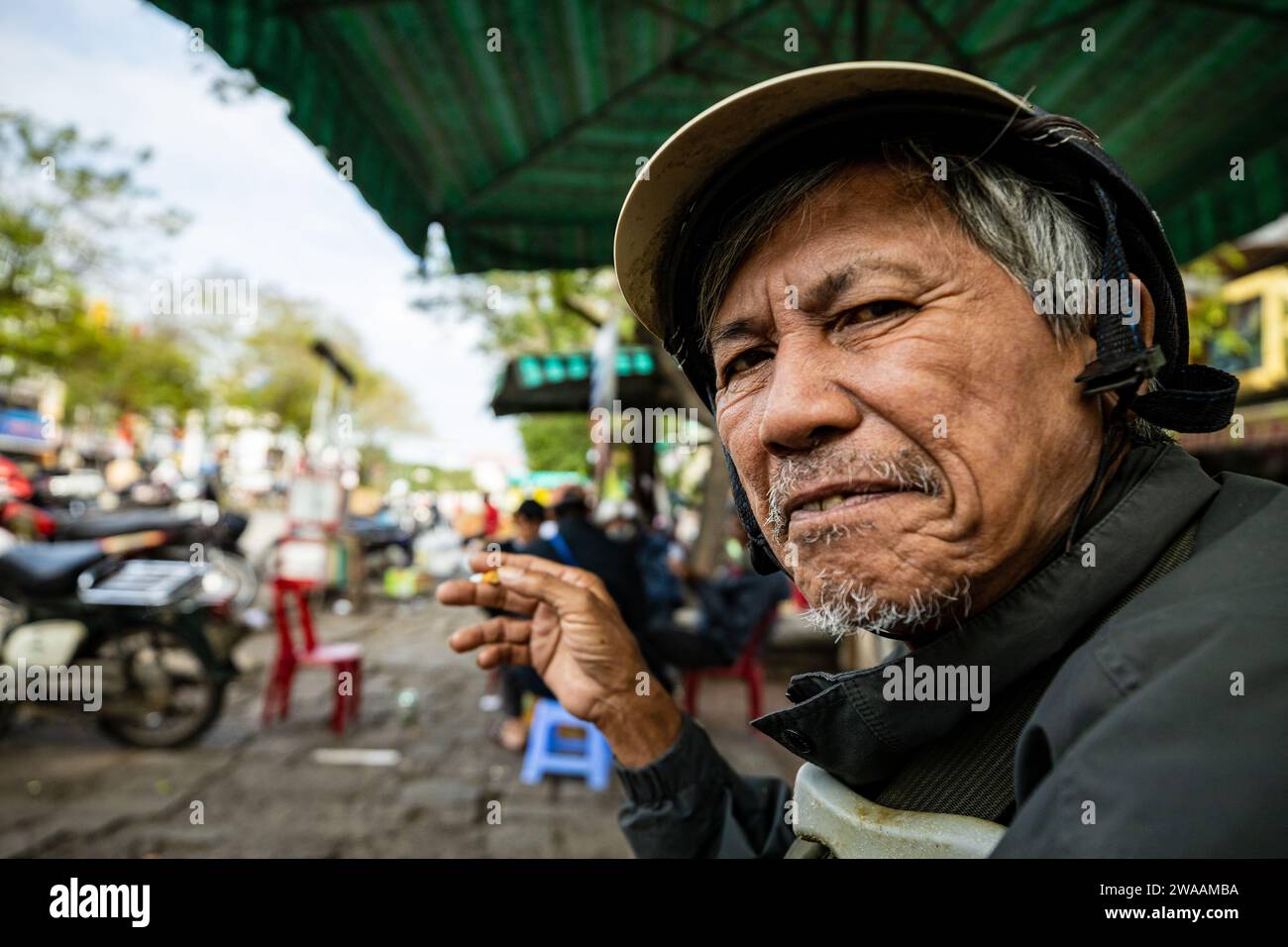 A man from Vietnam is smoking a cigarette Stock Photo - Alamy