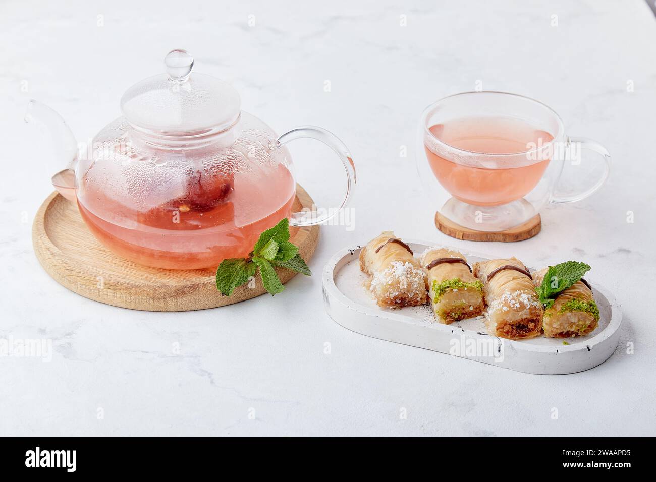 Turkish delight baklava and vitaminized healthy tea with cranberry, mint and sea buckthorn. Aesthetic tea time. Stock Photo