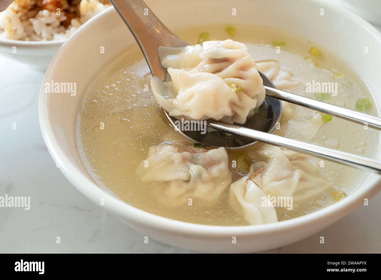 Wonton dumpling soup, distinctive and famous cuisine of Taiwanese street food. Stock Photo