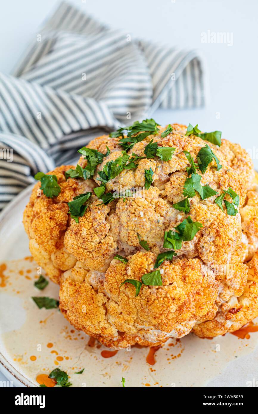 Roasted whole spicy cauliflower with tahini dressing Stock Photo - Alamy