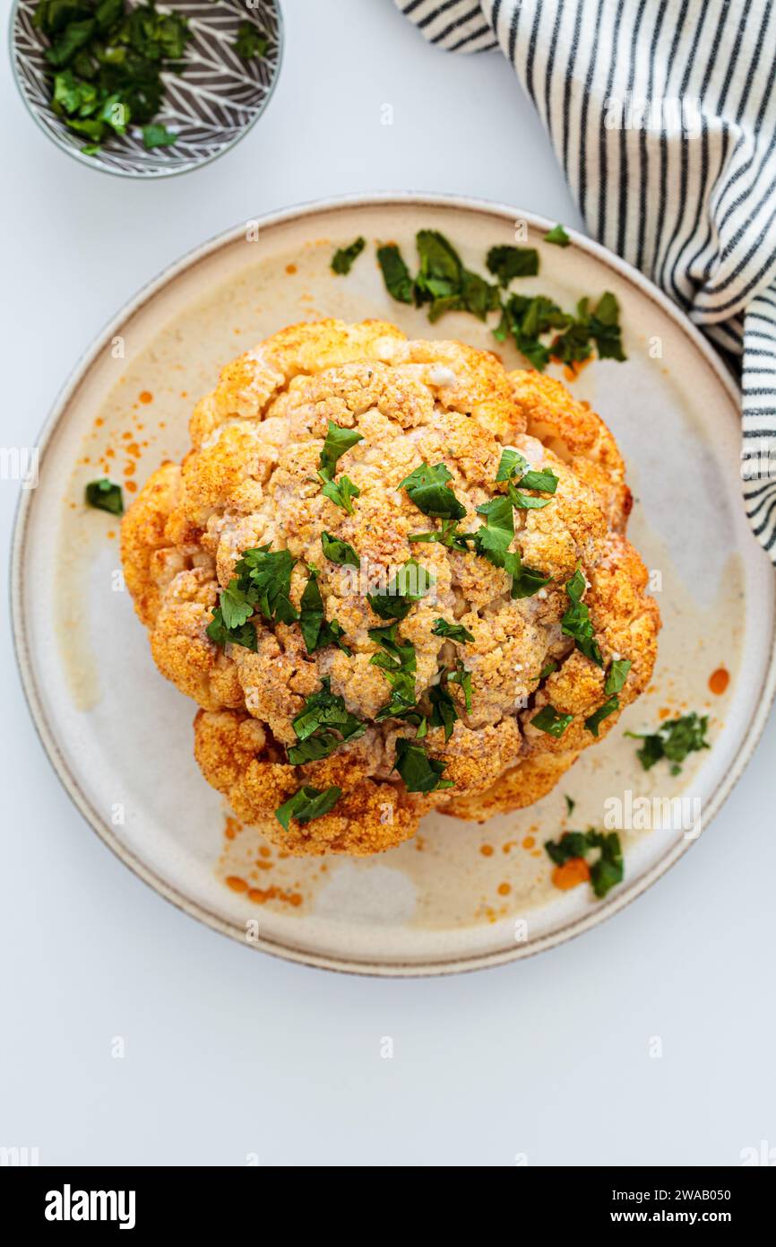 Roasted whole spicy cauliflower with tahini dressing Stock Photo - Alamy