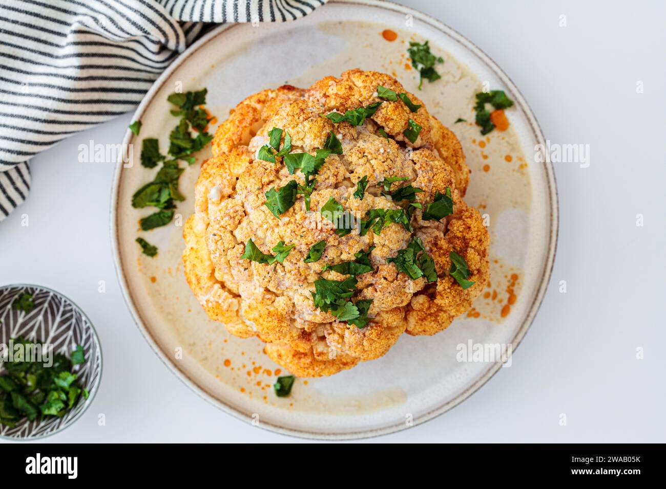 Roasted whole spicy cauliflower with tahini dressing Stock Photo - Alamy