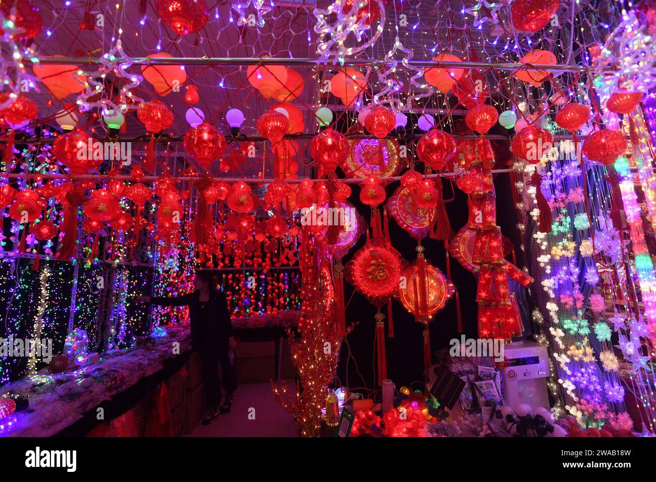 SHENYANG, CHINA - JANUARY 3, 2024 - People buy Spring Festival couplets, lanterns and dolls at a wholesale market in Shenyang, Northeast China's Liaon Stock Photo