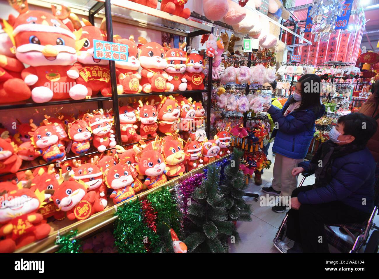 SHENYANG, CHINA - JANUARY 3, 2024 - People buy Spring Festival couplets, lanterns and dolls at a wholesale market in Shenyang, Northeast China's Liaon Stock Photo