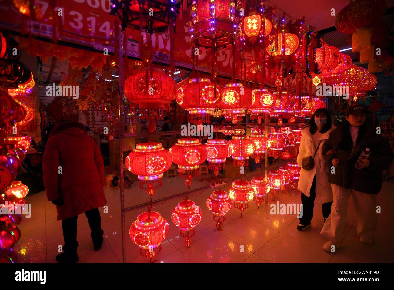 SHENYANG, CHINA - JANUARY 3, 2024 - People buy Spring Festival couplets, lanterns and dolls at a wholesale market in Shenyang, Northeast China's Liaon Stock Photo