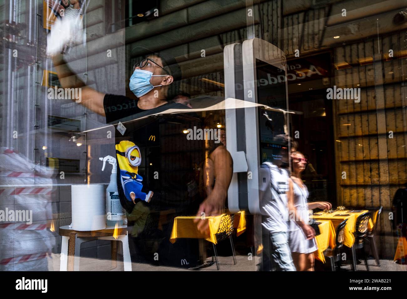 Rome, Italy - 12 August 2022 : Man cleaning a McDonalds window Stock Photo
