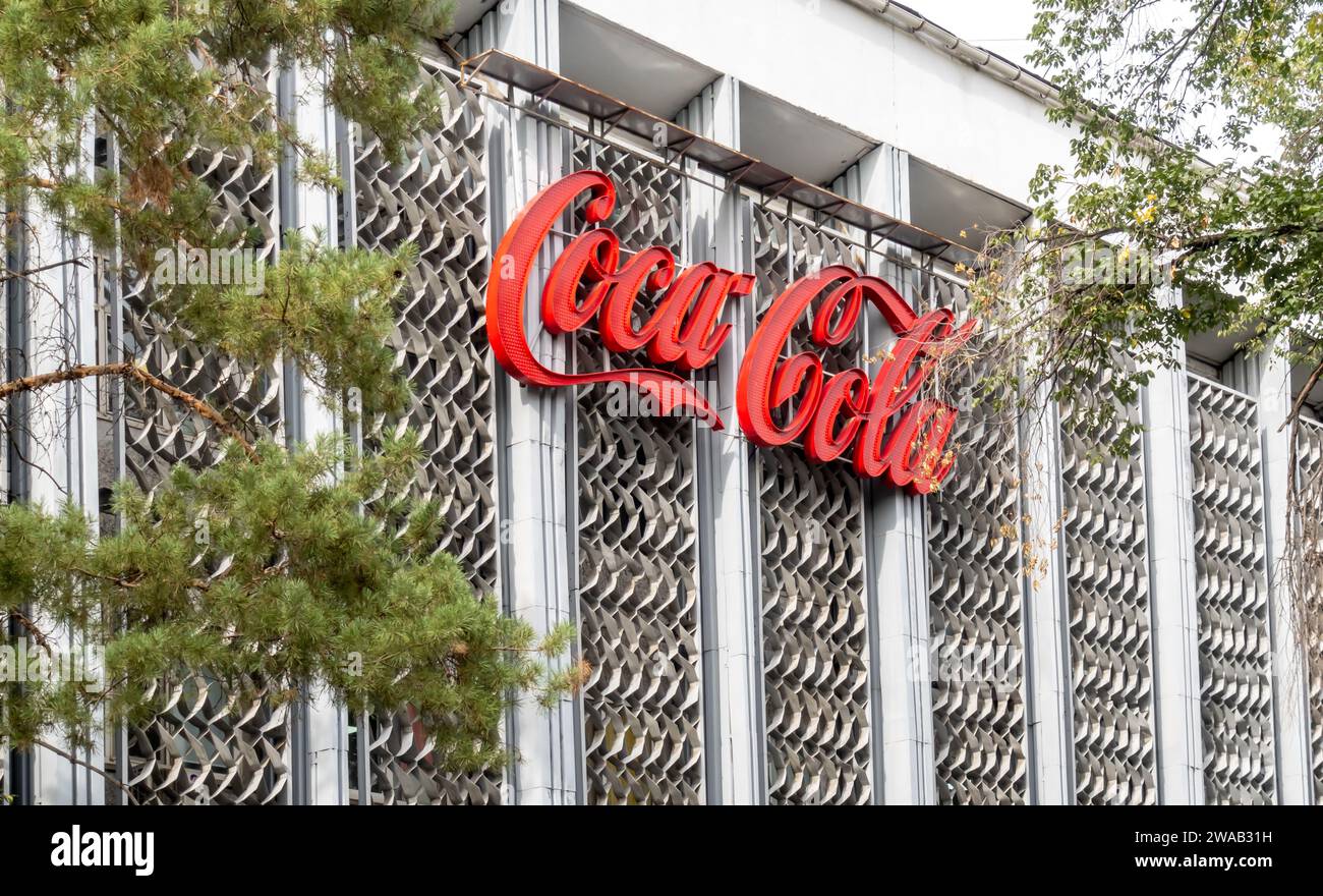 Cci Kazakhstan modernist building with Coca-Cola sign advertisement, Almaty Stock Photo