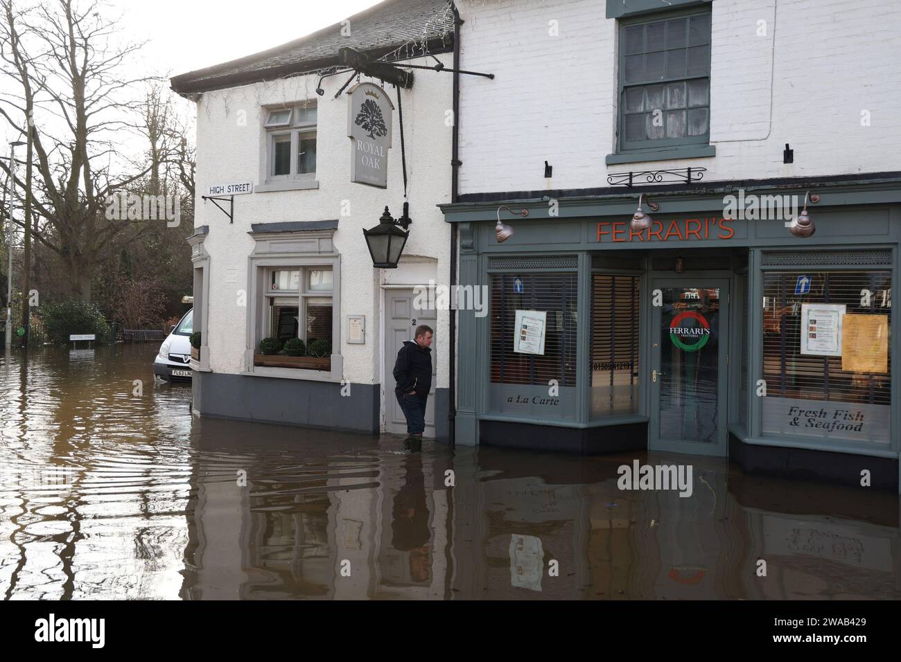 Quorn, Leicestershire, UK. 3rd January 2024. UK weather. A man wades past a pub sitting in flood water. Heavy rain and wind has battered large swathes of the UK after the small but potent Storm Henk hit.  Credit Darren Staples/Alamy Live News. Stock Photo