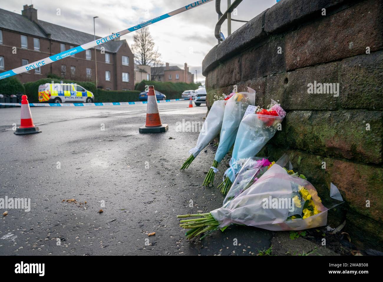 Floral tributes left close to the scene near the Anchor Inn in Granton, Edinburgh, where Marc Webley, aged 38, was killed in a shooting just before midnight on New Year's Eve. Picture date: Wednesday January 3, 2024. Stock Photo