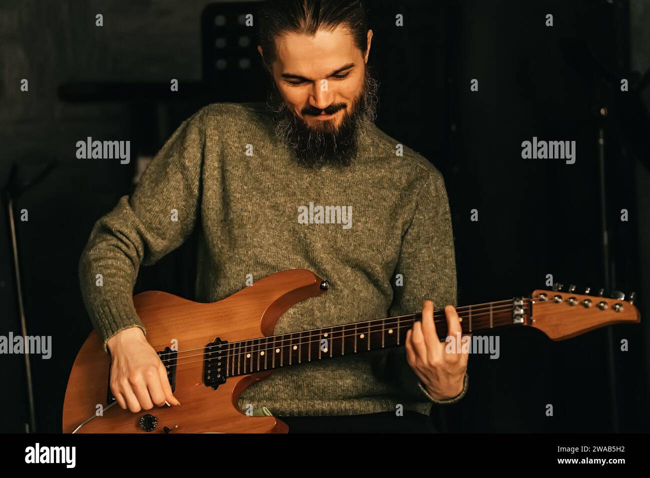 Guitarist play guitar. Concept of music recording studio or band rehearsal and practice. Stock Photo