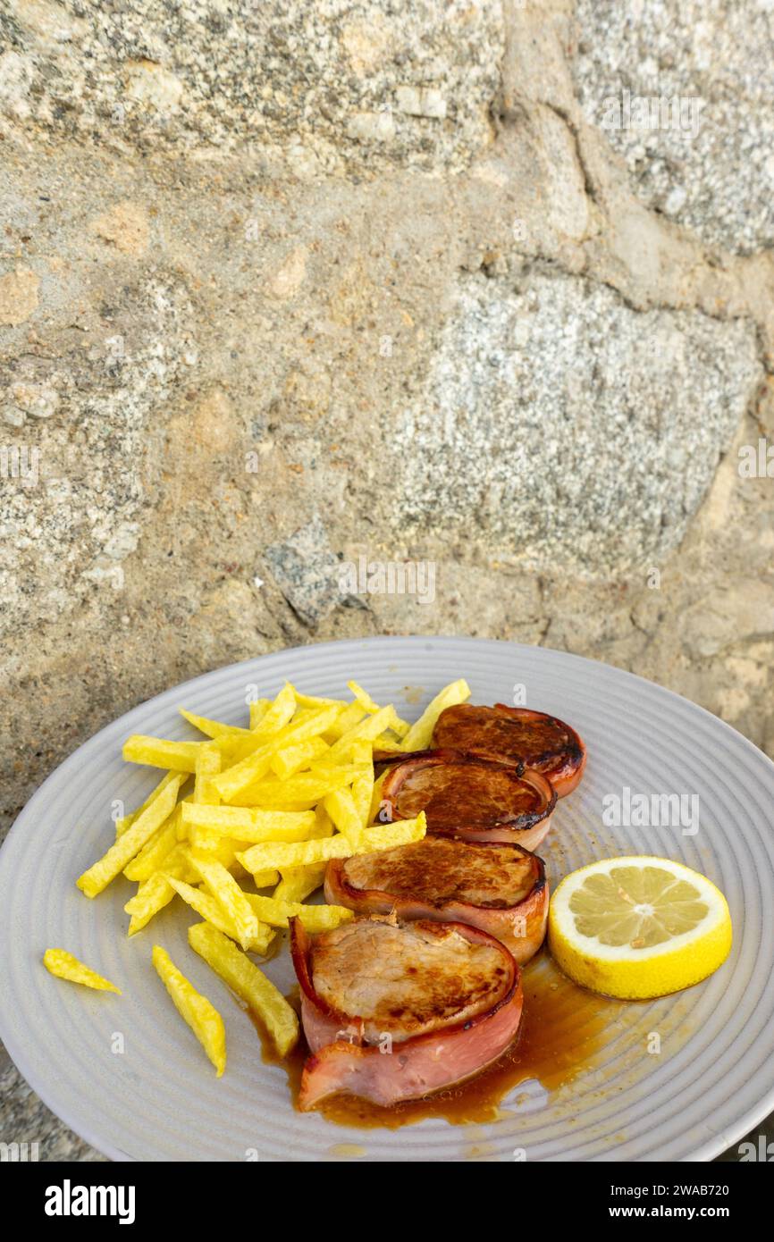 Delicious Portuguese pork tenderloin wrapped in bacon, served with
