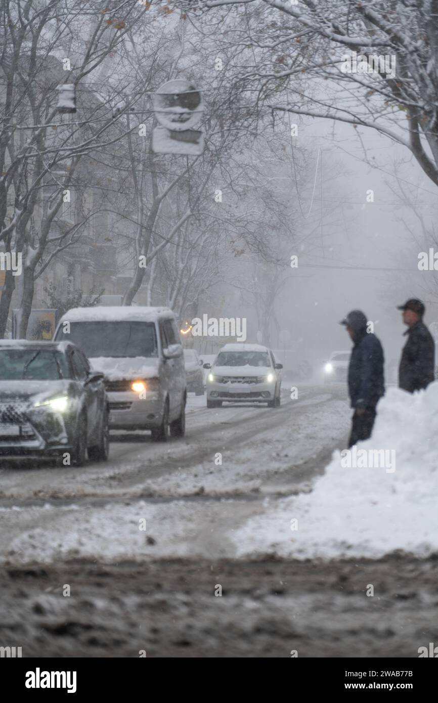 Snowy city street with cars in traffic, winter day Stock Photo - Alamy