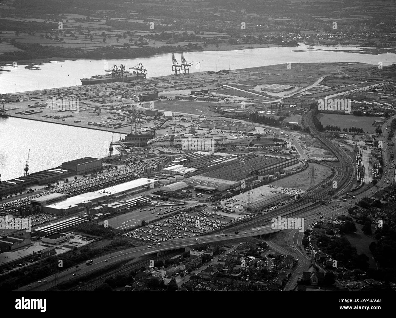 Arial view of Southampton Western Docks with the recent constructed container port in the distance and SS Canberra in the King George V dry dock taken in the mid 1980s, Southampton, Hampshire, England, UK Stock Photo