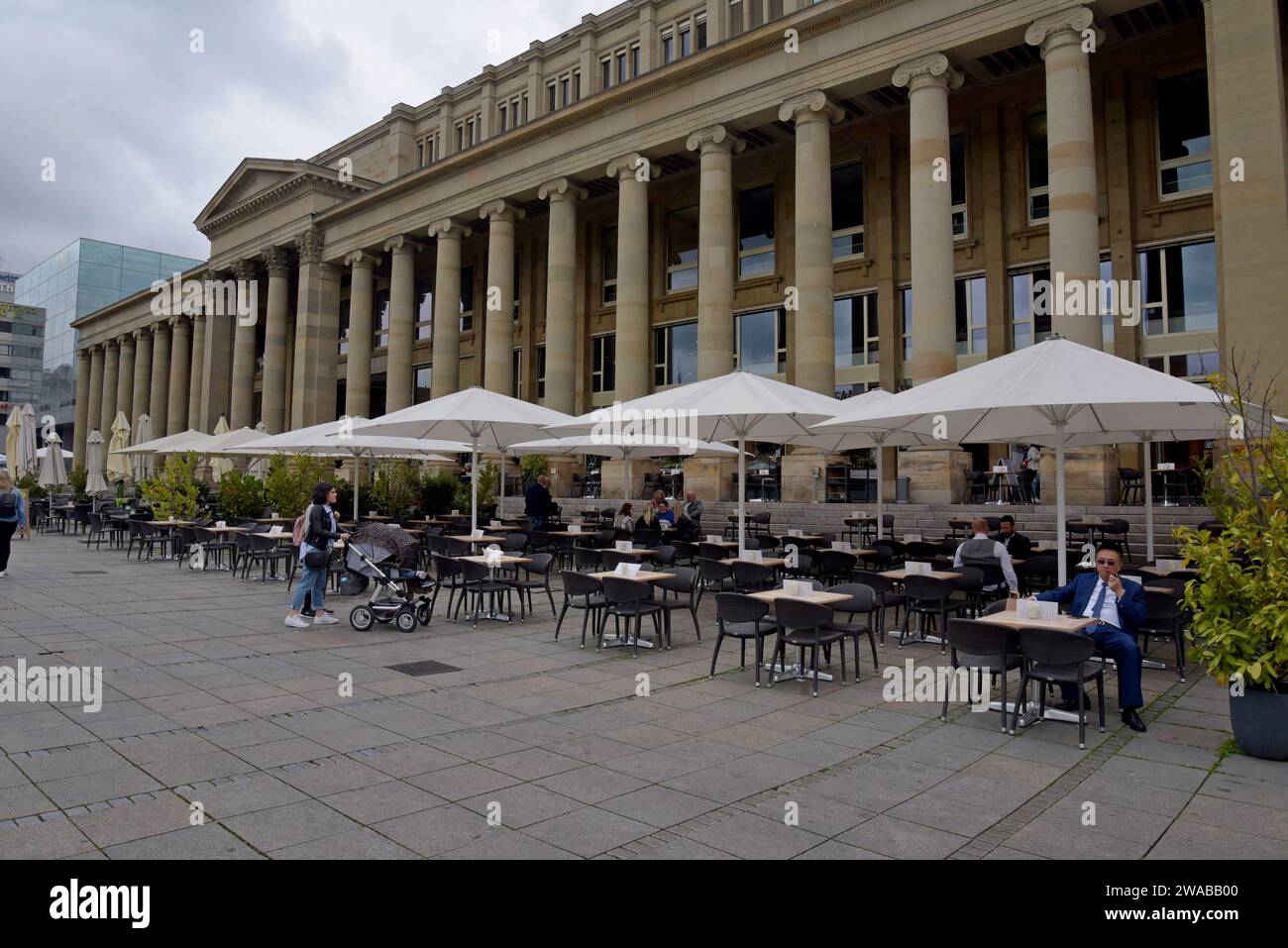 People at outdoor cafe tables outside the Königsbau building,    Schlossplatz, Stuttgart, Germany, May 2023 Stock Photo