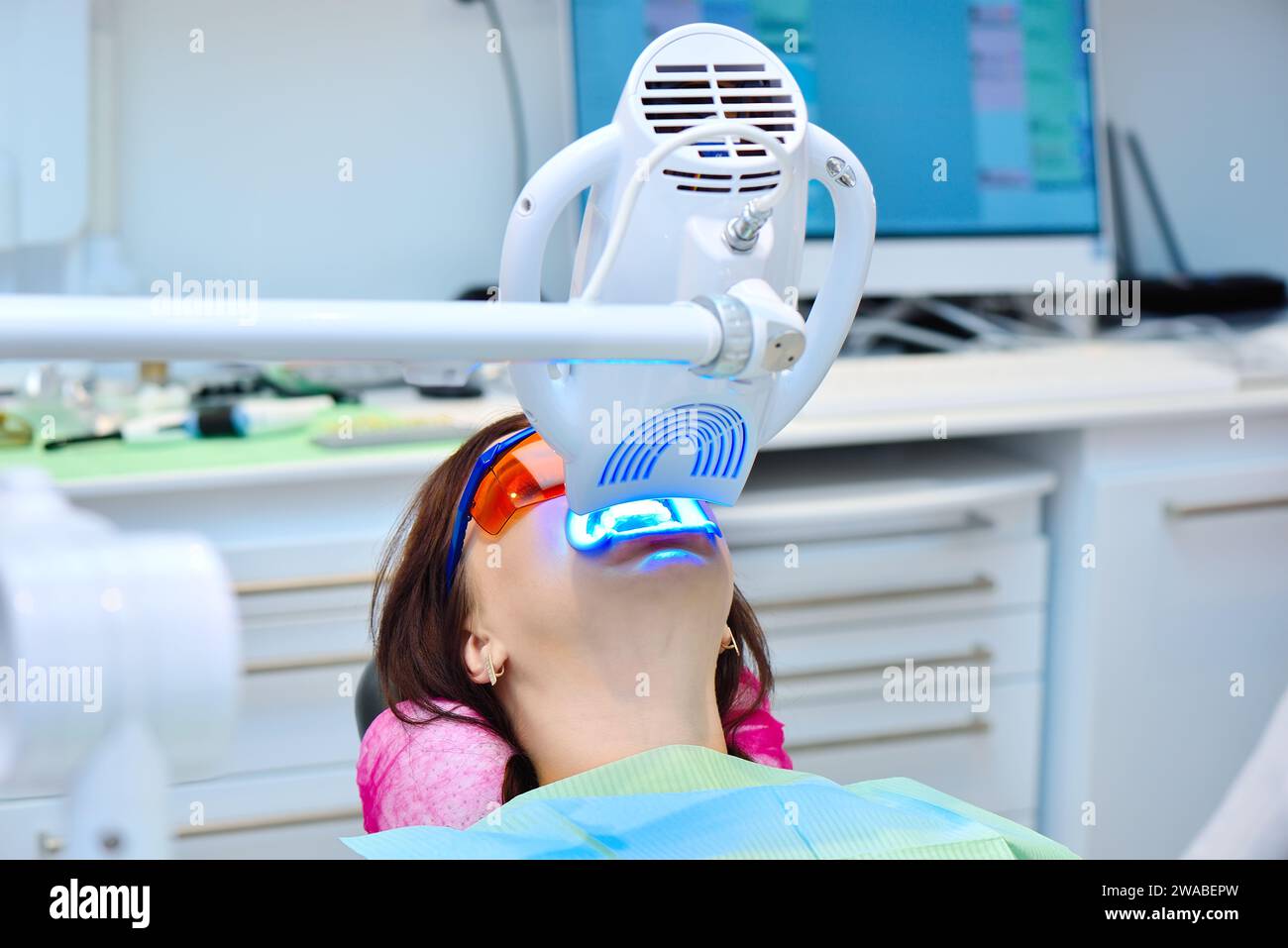 Laser bleaching teeth in clinic. Teeth whitening for patient. Bleaching of teeth at dentist