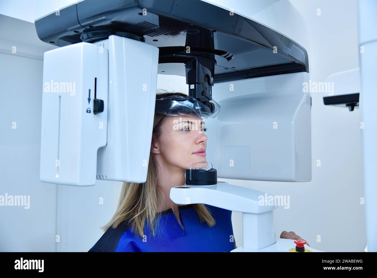 Woman patient make a panoramic computer tomograph in clinic. Dentistry and health care concept. Stock Photo