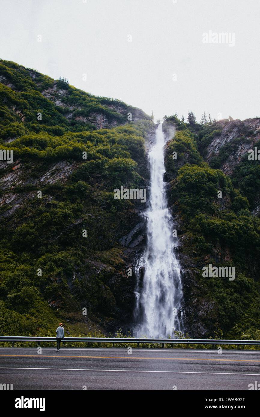 Woman stands in front of waterfall in Valdez, Alaska Stock Photo - Alamy