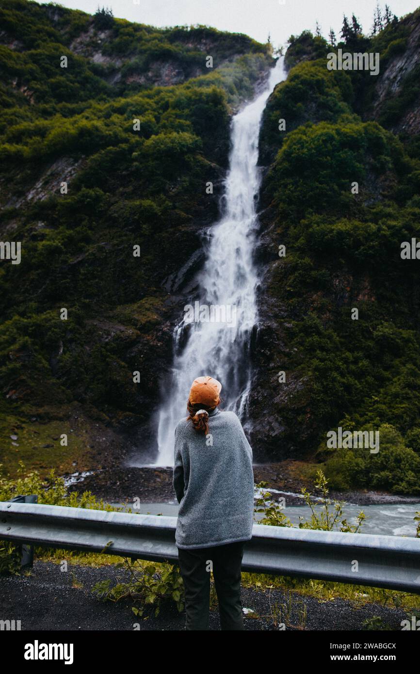 Woman stands in front of waterfall in Valdez, Alaska Stock Photo - Alamy