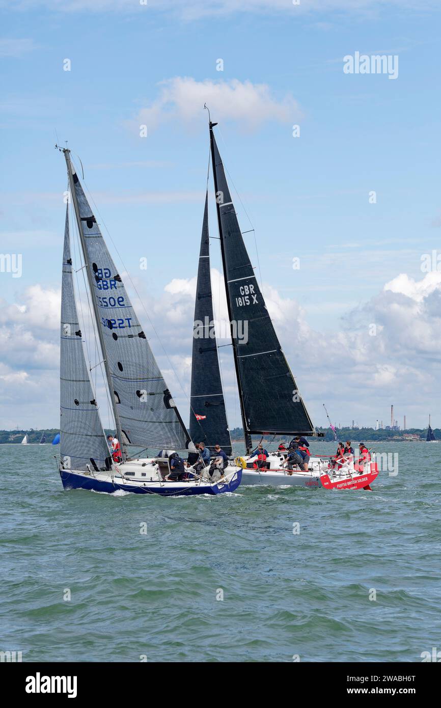 Two Sailing Yachts GBR90227 Touchpaper, a Corby and GBR1815X Fujitsu British Soldier a Jeanneau Sunfast 3600 at close quarters during a sailboat race Stock Photo