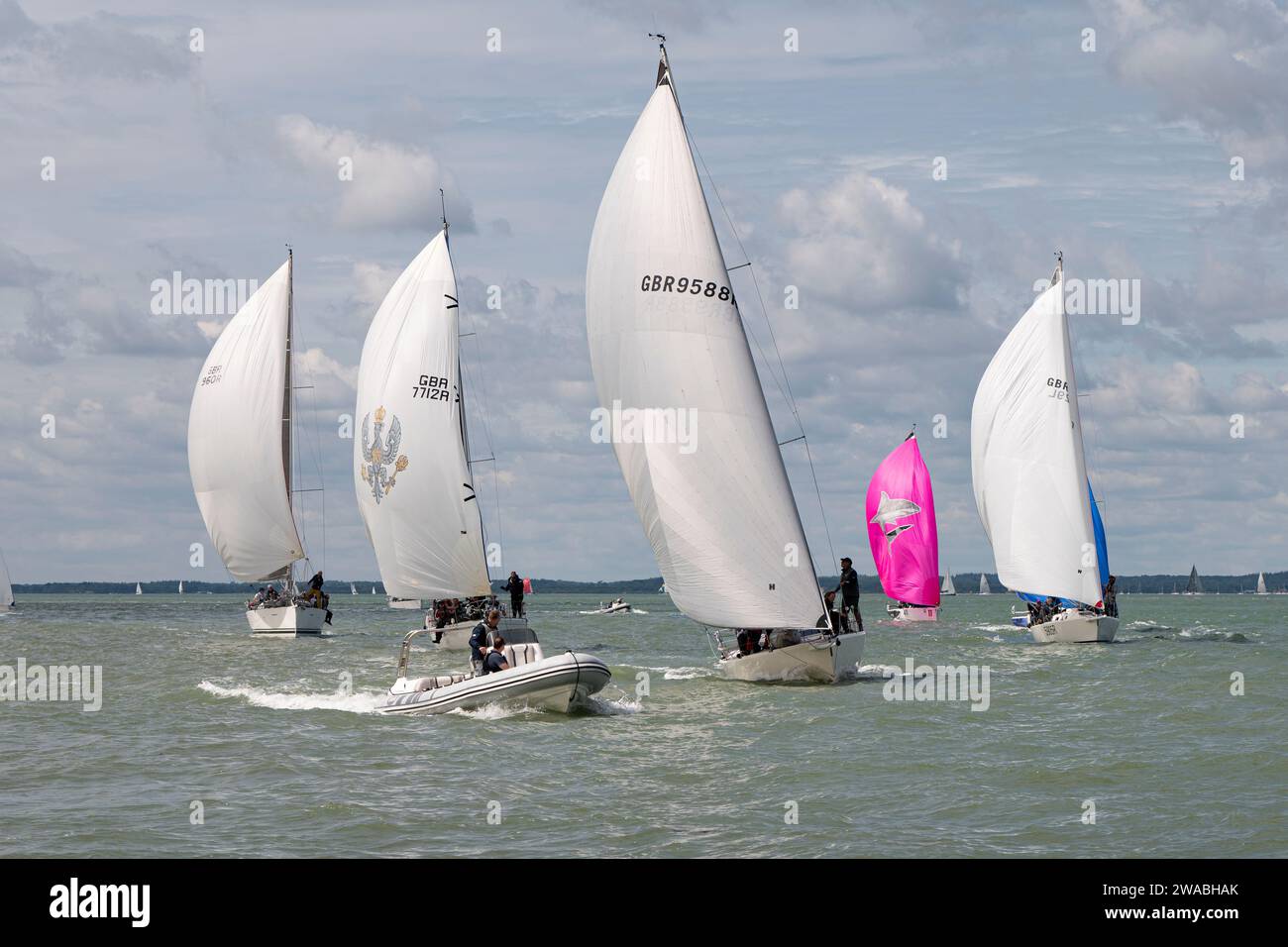 Close sailboat racing during the Cowes Week sailing regatta held in the Solent off the north coast of the Isle of Wight in Southern England Stock Photo