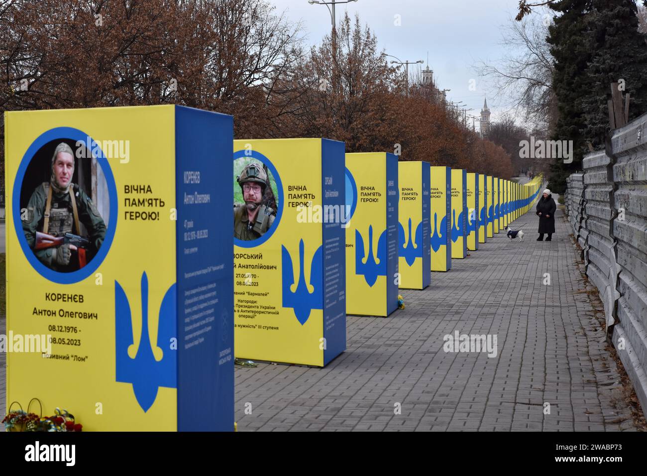 A woman with a dog walks past stands of portraits of fallen Ukrainian soldiers in the center of Zaporizhzhia. Ukrainian President Volodymyr Zelenskiy said Russian forces are suffering heavy losses and the notion that Moscow is winning the nearly two-year-old war is only a 'feeling' not based on reality. There was no response to a request for comment from Russian officials on Zelenskiy's remarks. Russian officials have said Western estimates of Russian death tolls are vastly exaggerated and almost always underestimate Ukrainian losses. Stock Photo