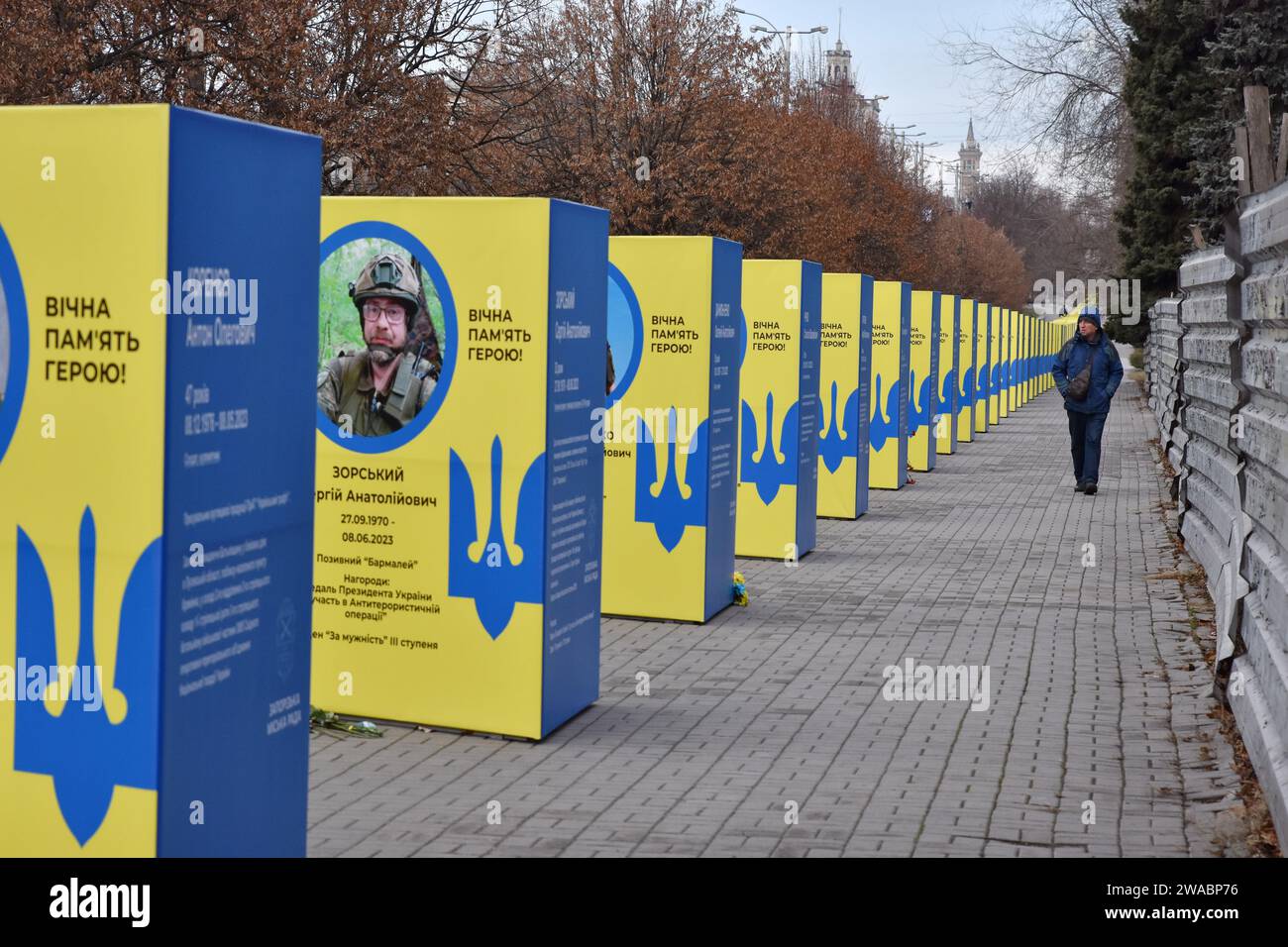 A man walks past stands of portraits of fallen Ukrainian soldiers in the center of Zaporizhzhia. Ukrainian President Volodymyr Zelenskiy said Russian forces are suffering heavy losses and the notion that Moscow is winning the nearly two-year-old war is only a 'feeling' not based on reality. There was no response to a request for comment from Russian officials on Zelenskiy's remarks. Russian officials have said Western estimates of Russian death tolls are vastly exaggerated and almost always underestimate Ukrainian losses. Stock Photo