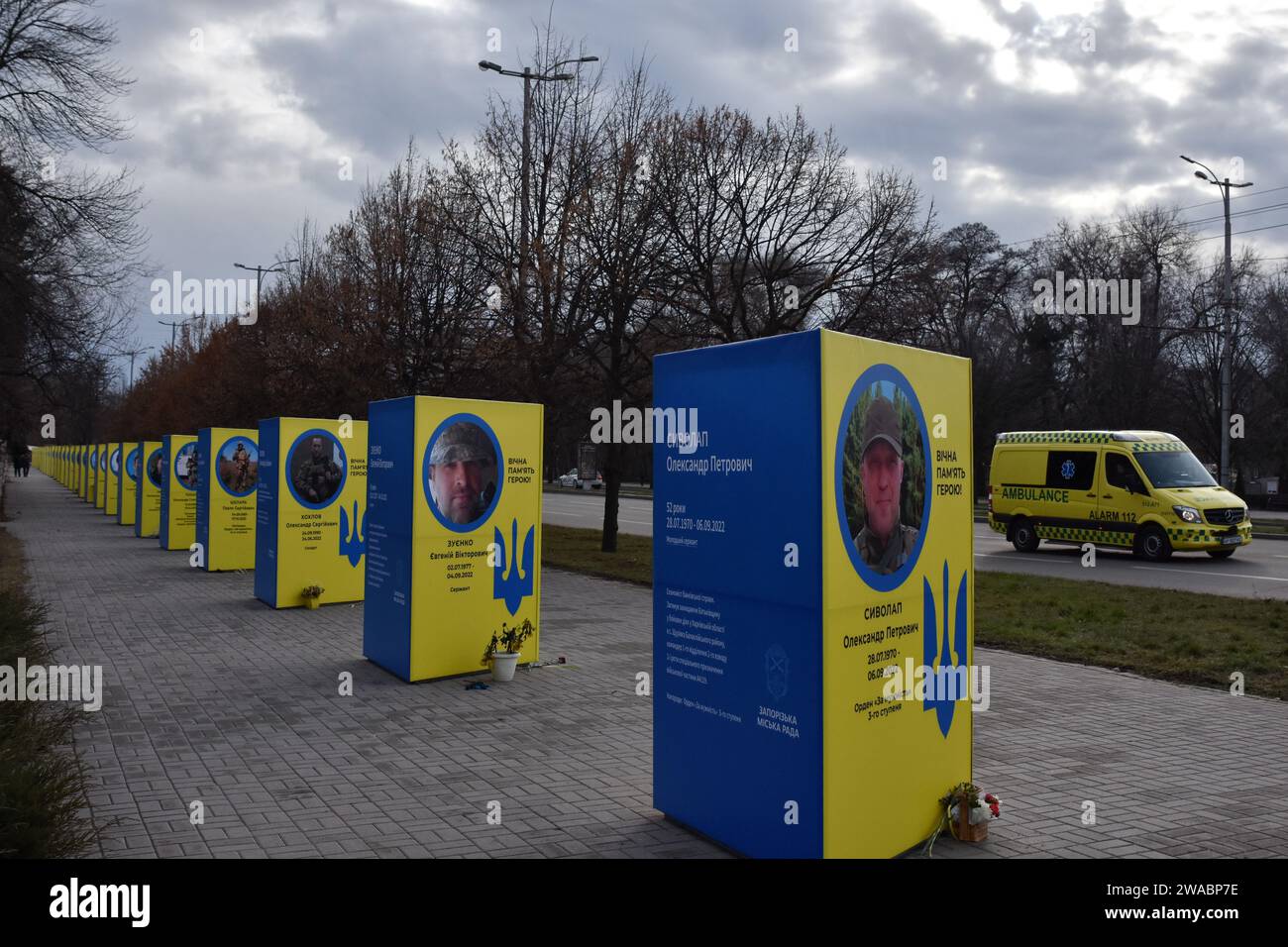 An ambulance drives down the road past stands of portraits of fallen Ukrainian soldiers in the center of Zaporizhzhia. Ukrainian President Volodymyr Zelenskiy said Russian forces are suffering heavy losses and the notion that Moscow is winning the nearly two-year-old war is only a 'feeling' not based on reality. There was no response to a request for comment from Russian officials on Zelenskiy's remarks. Russian officials have said Western estimates of Russian death tolls are vastly exaggerated and almost always underestimate Ukrainian losses. Stock Photo