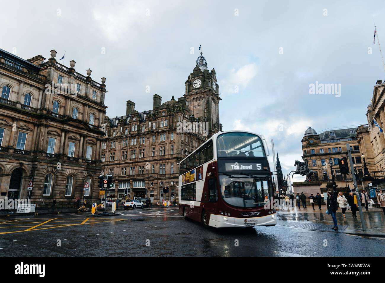Edinburgh, UK - December 5, 2023: Princess Street during Christmas time a rainy day. Double decker bus Stock Photo