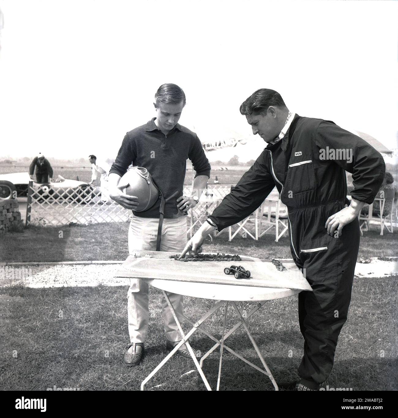 1962, historical, a young man, holding crash helmet, with instructor at ...