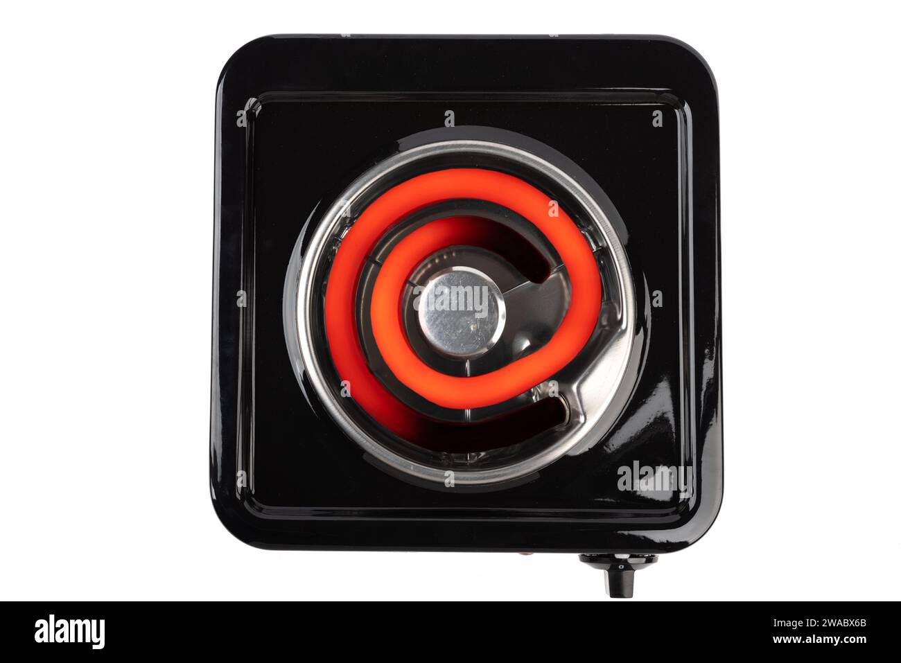 Top view of a tabletop electric stove with a hot heating element. White