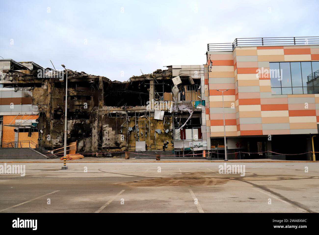 War in Ukraine, missile strike by Russians on shopping center, store, civilian building in Ukraine. Russians burned and destroyed building. War, destr Stock Photo