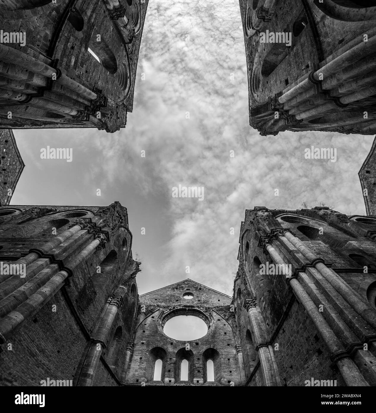 Missing ceiling opening the view to the sky in the destroyed abandoned Cistercian monastery San Galgano in the Tuscany, Italy Stock Photo