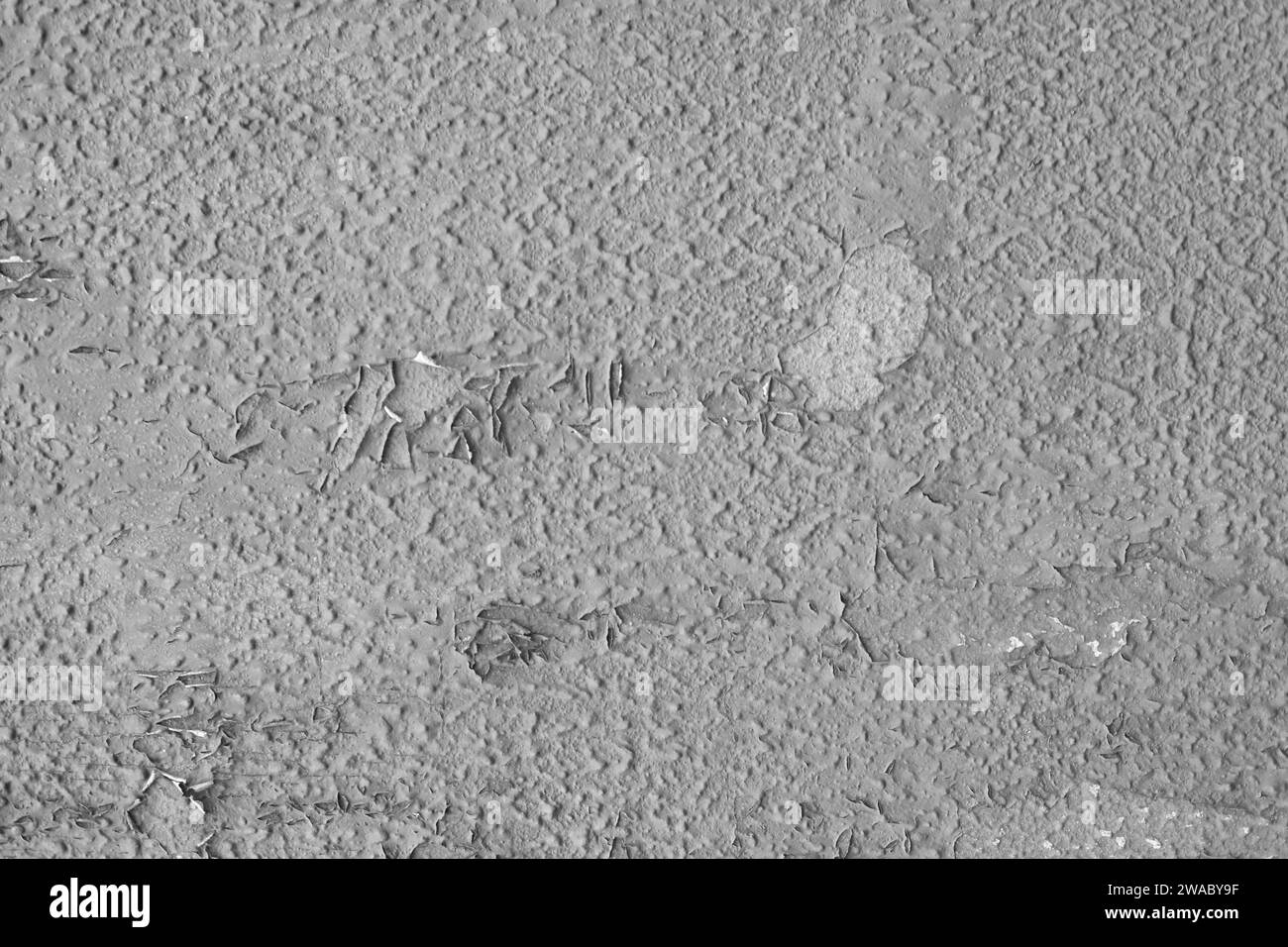 Texture of peeling old gray paint on the wall. Design pattern, wall