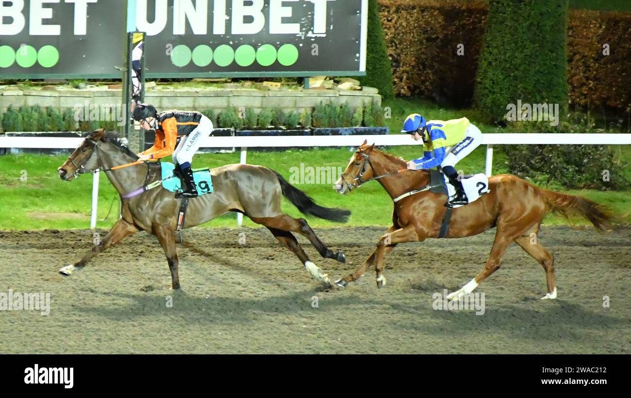 London, UK. 3rd January 2023. McCauley's Tavern (Black Cap), ridden by Billy Loughnane, wins the 18.00 Unibet 3 Boosts A Day Handicap Stakes, ahead of Libra Tiger (number 2), ridden by Daniel Muscatt, at Kempton Park Racecourse, UK. Credit: Paul Blake/Alamy Live News. Stock Photo