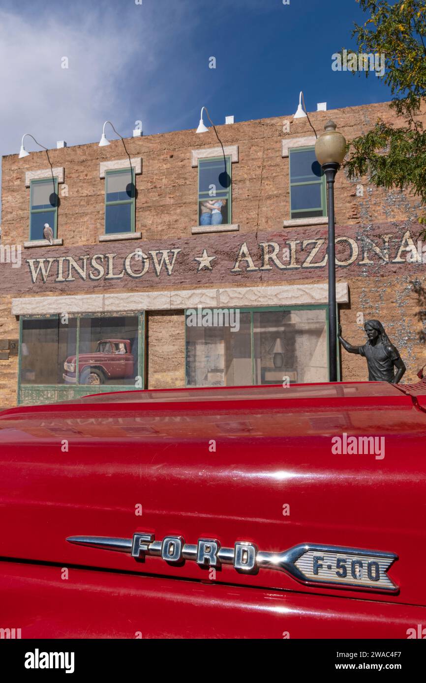 Red Ford flatbed truck wit statue of Glenn Frey, StandingOnACorner